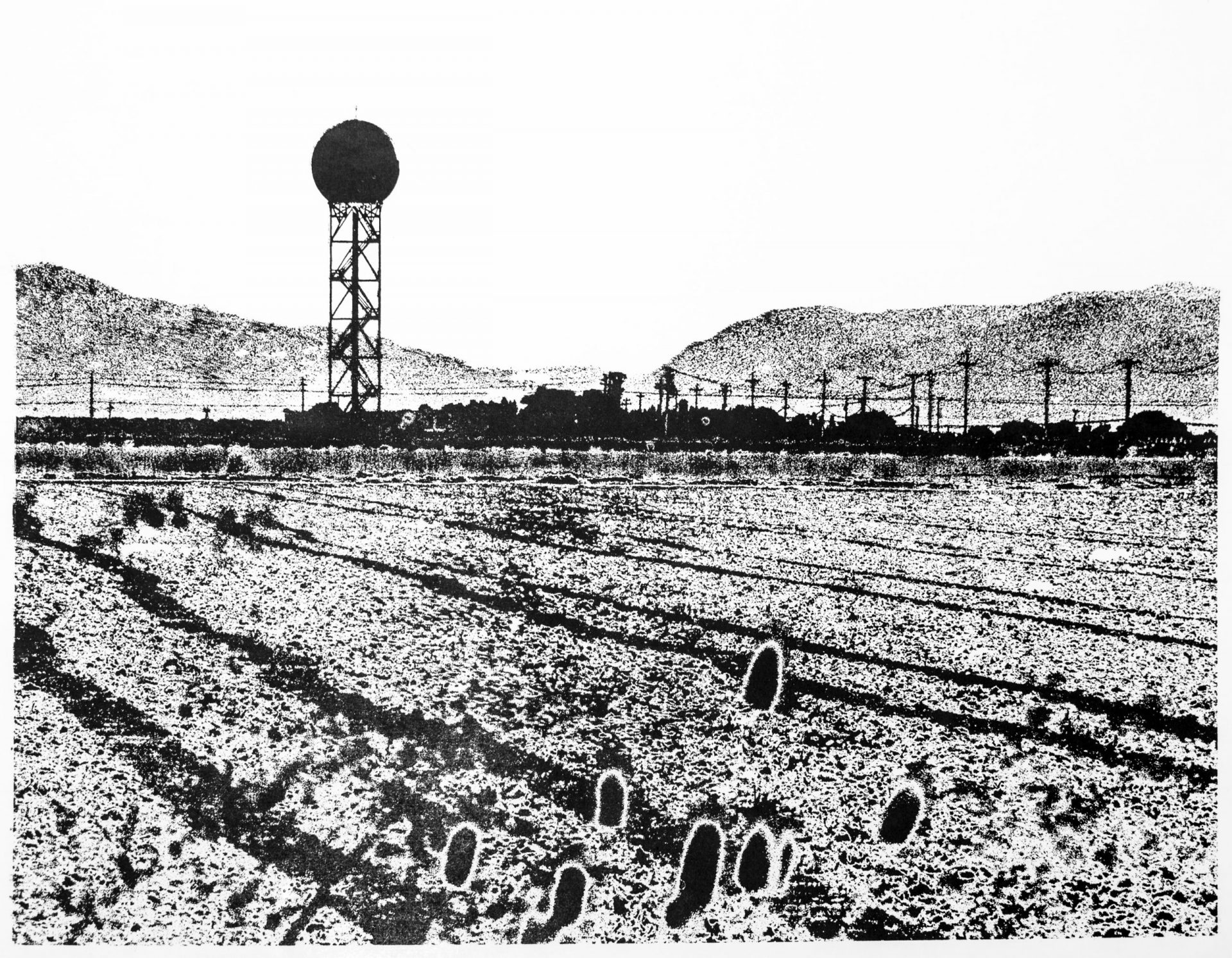 Black and white relief print of a landscape with furrows in the foreground, a doppler radar tower and power lines in the midground, and a mountain gap in the background.